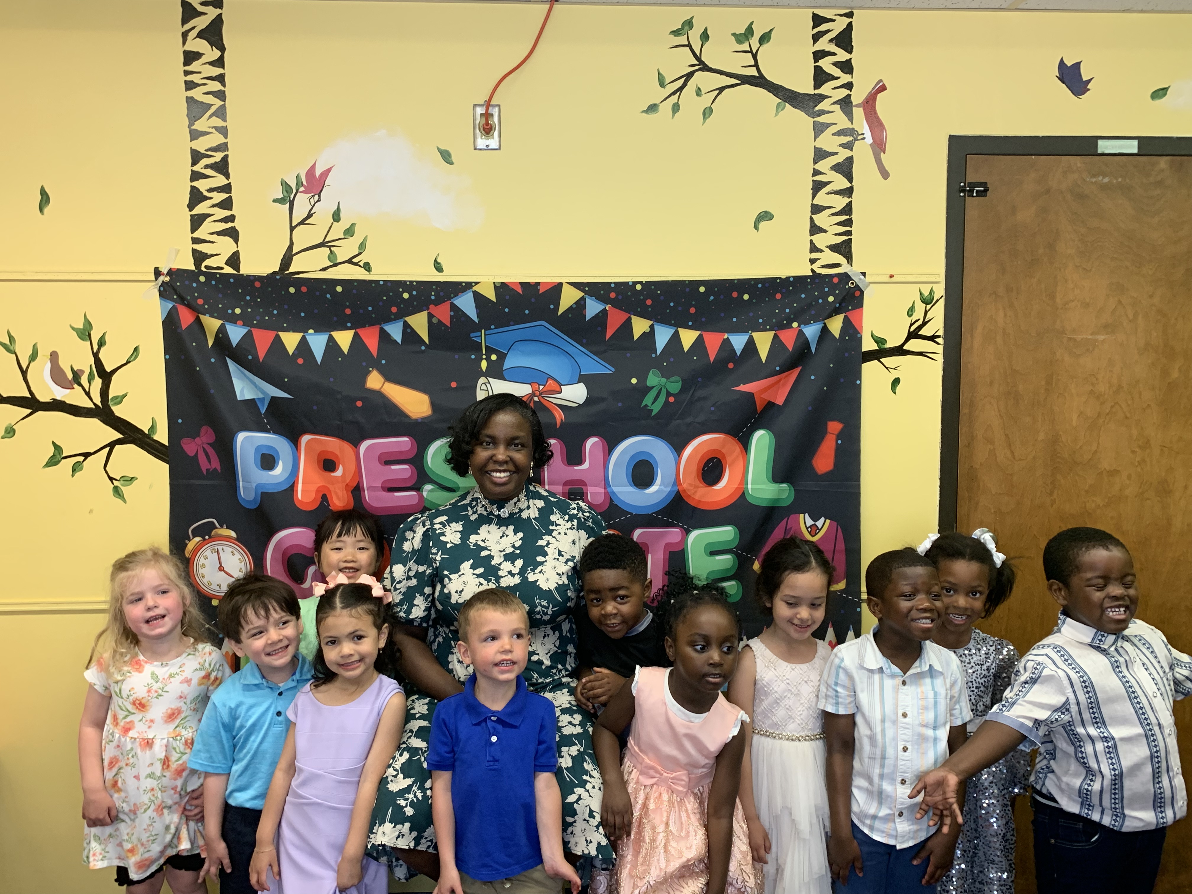 A teacher reading with preschoolers at Seeds of Wisdom