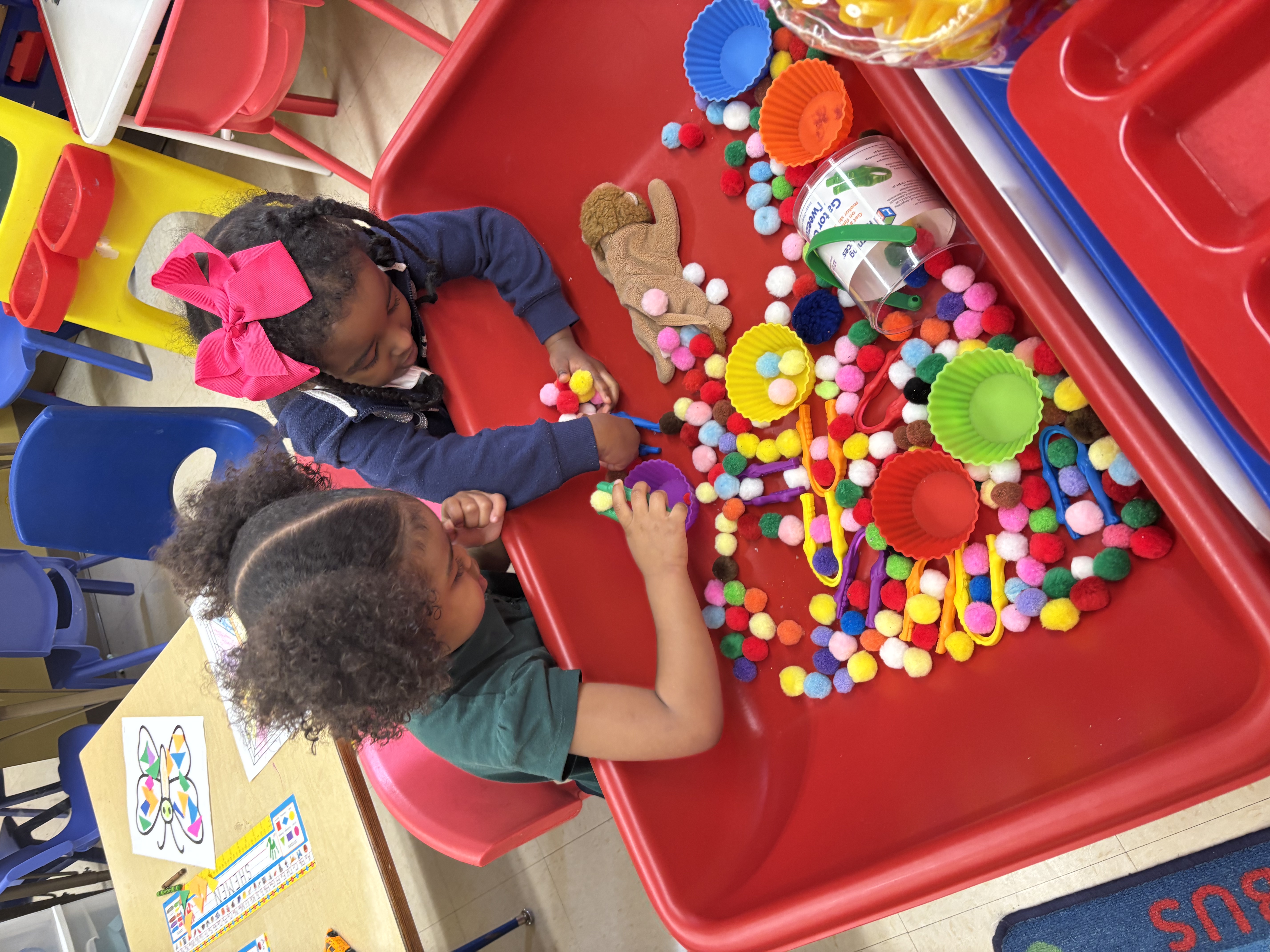A two-year-old exploring a play activity in the Beginnings classroom