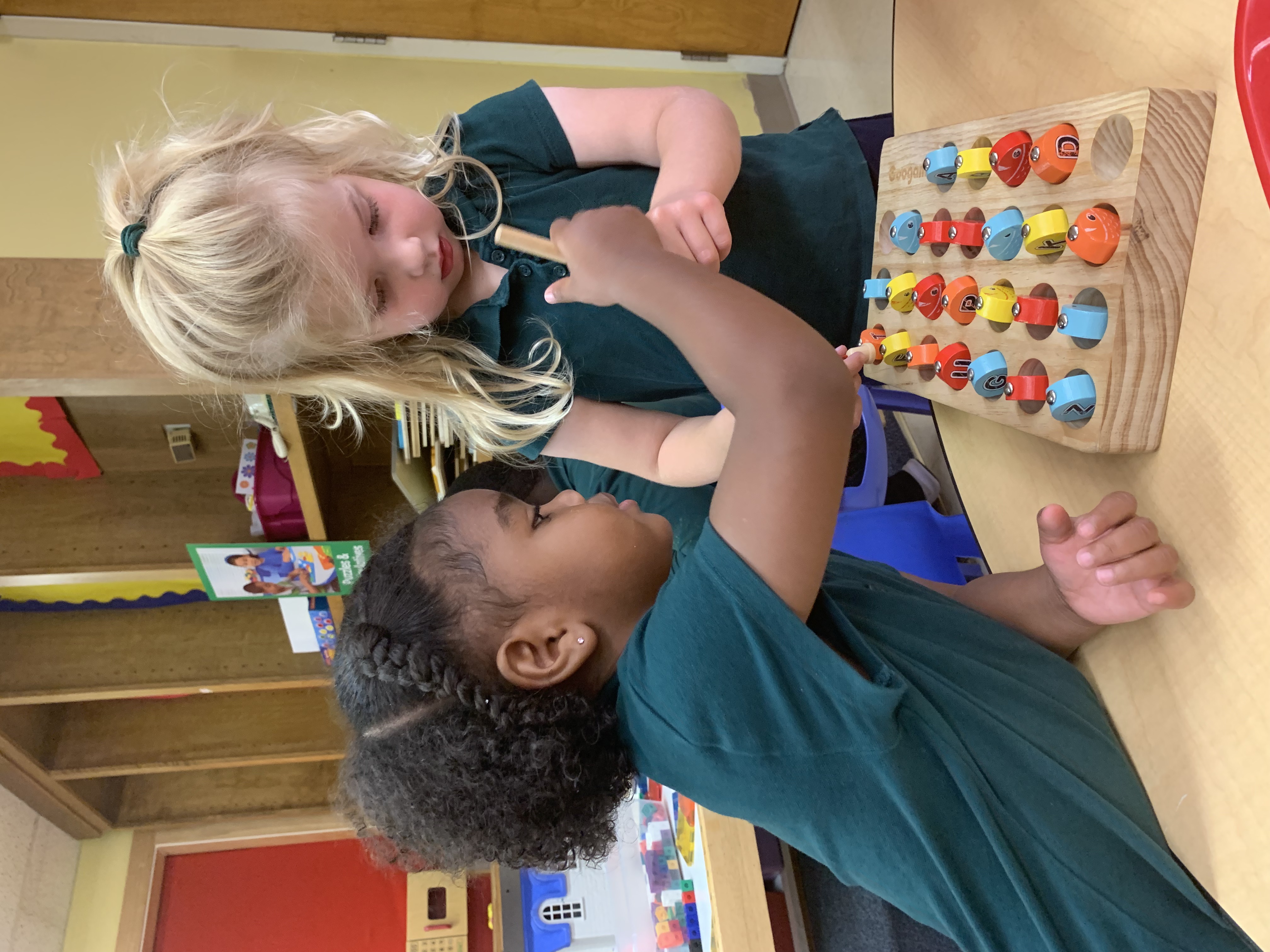 A bright, tidy classroom with child-sized furniture and learning materials